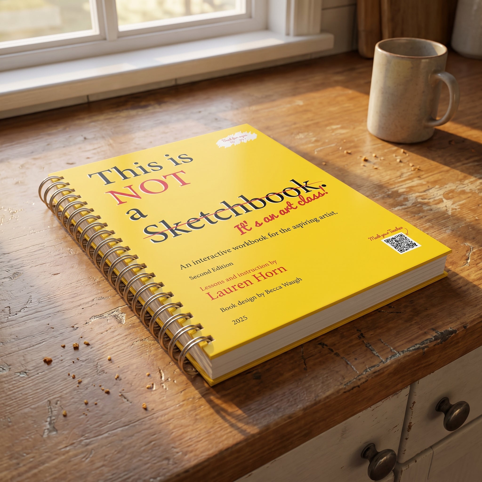 A closed spiral-bound workbook sitting on a kitchen counter in warm light, with no phone, laptop, or tablet in frame.
