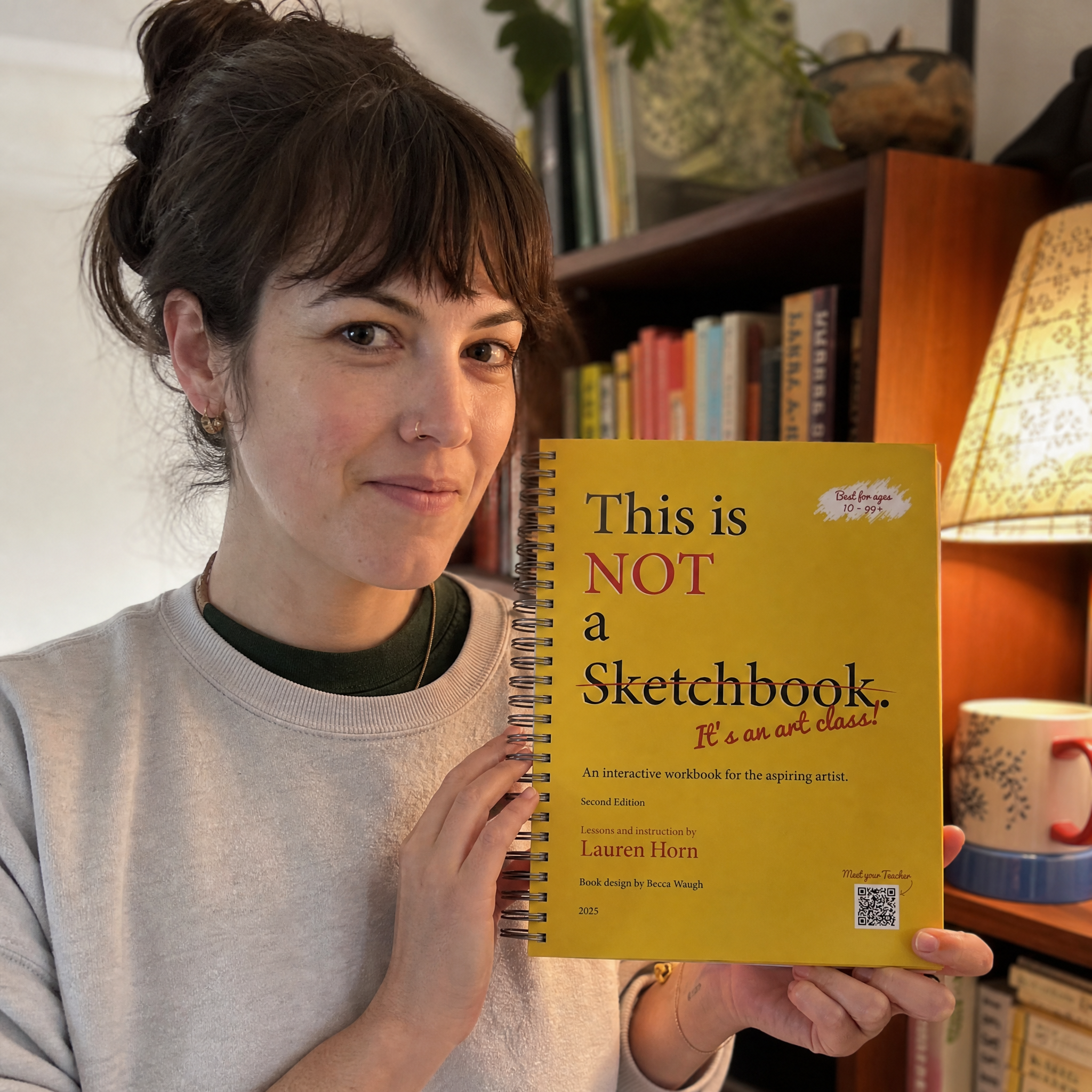 The art class book on a home shelf among other owned objects