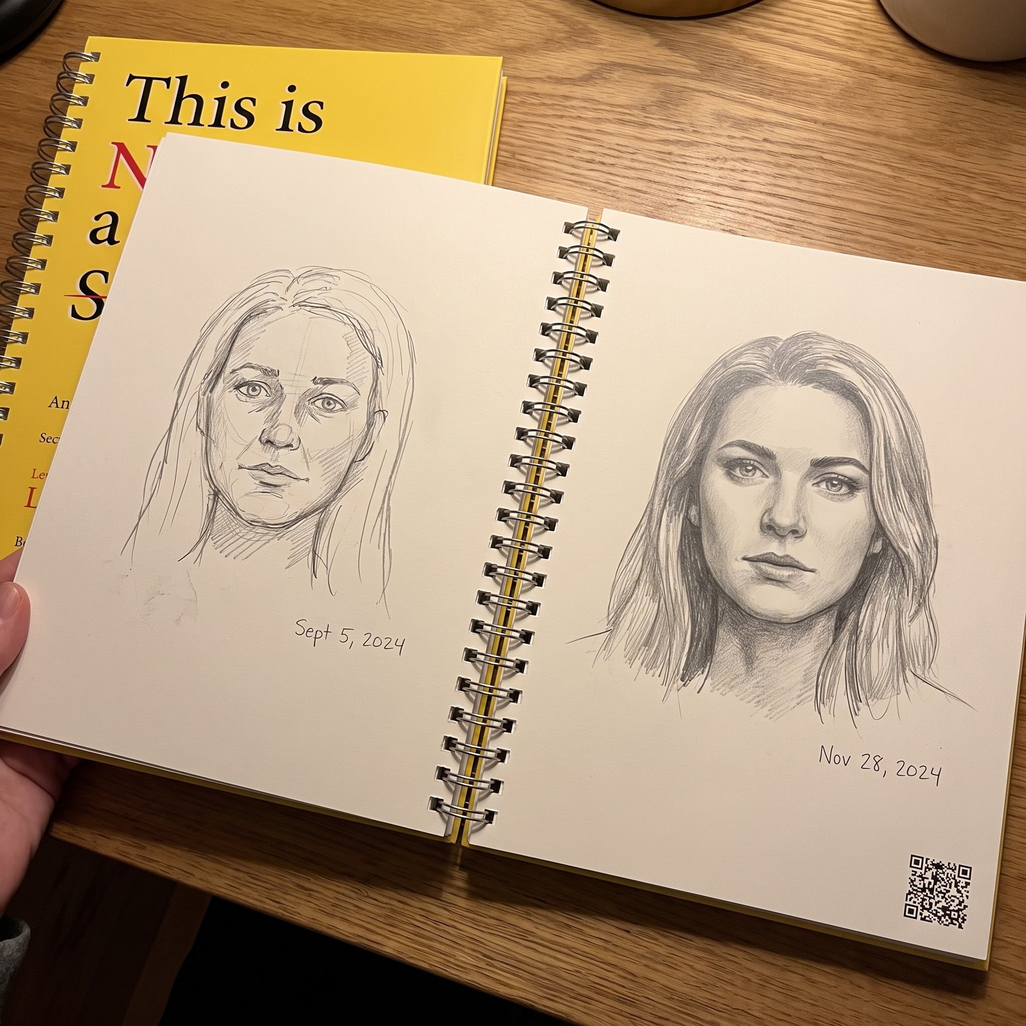 Two pencil self-portraits on facing workbook pages, a hesitant page-1 face and a more confident page-100 face, each with a date written beside it.